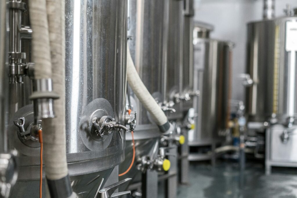 Fermentation tanks in brewery using enzymes for beer production and quality enhancement