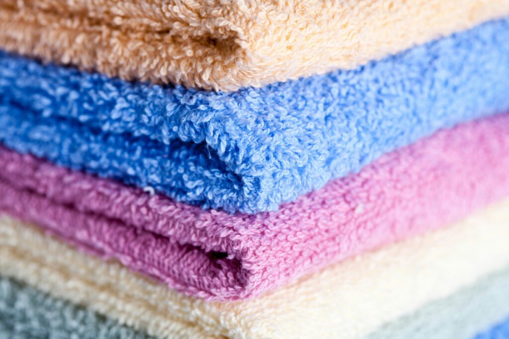Bright and colorful clothes washed effectively with enzyme-based detergents, highlighting deep cleaning, stain removal, and long-lasting fabric freshness